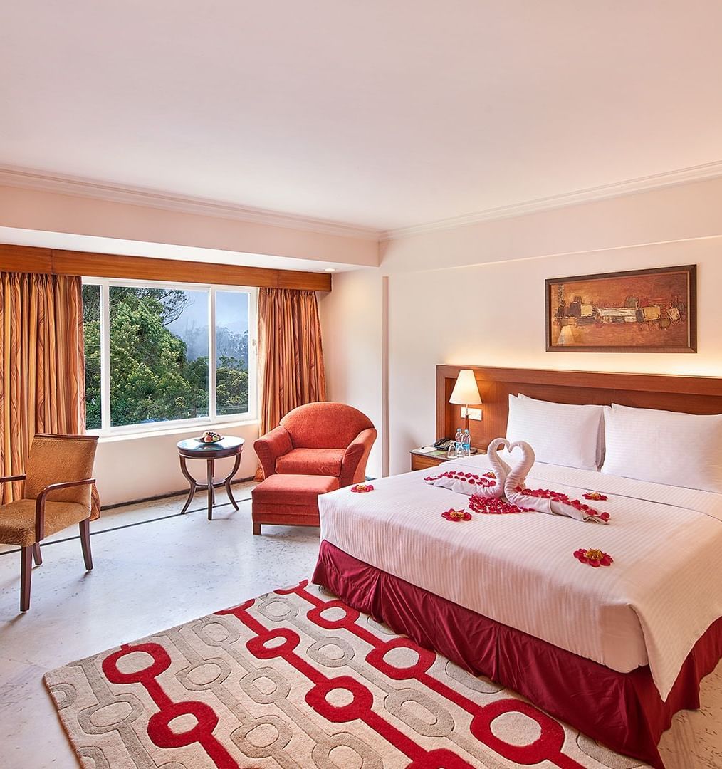 Superior Room at Accord Highland Ooty with a double bed, a television and a work desk and chair - One of the Best Hotels in Ooty